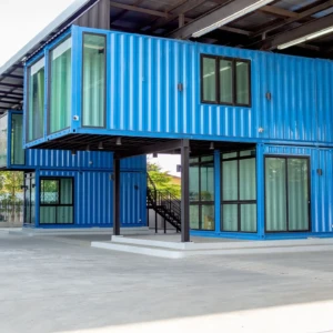 modern two-story shipping container commercial building featuring stacked blue 40ft containers